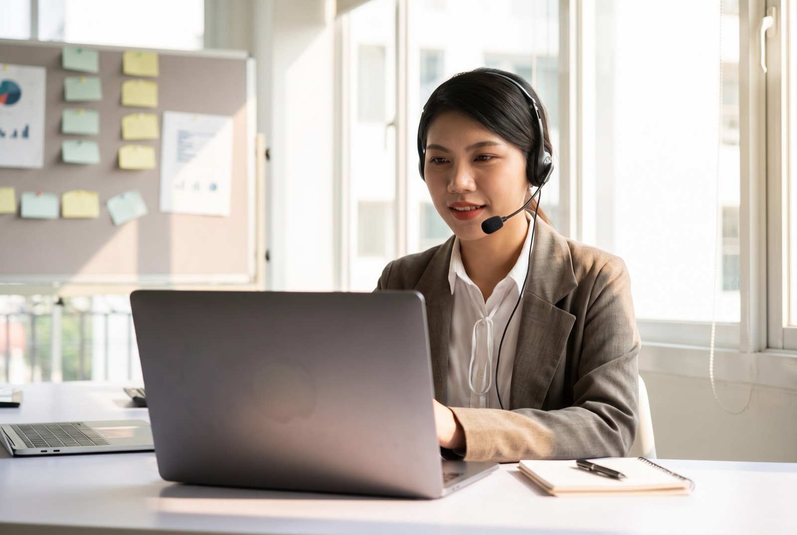 Candidate wearing a headset in a video interview during structured onboarding